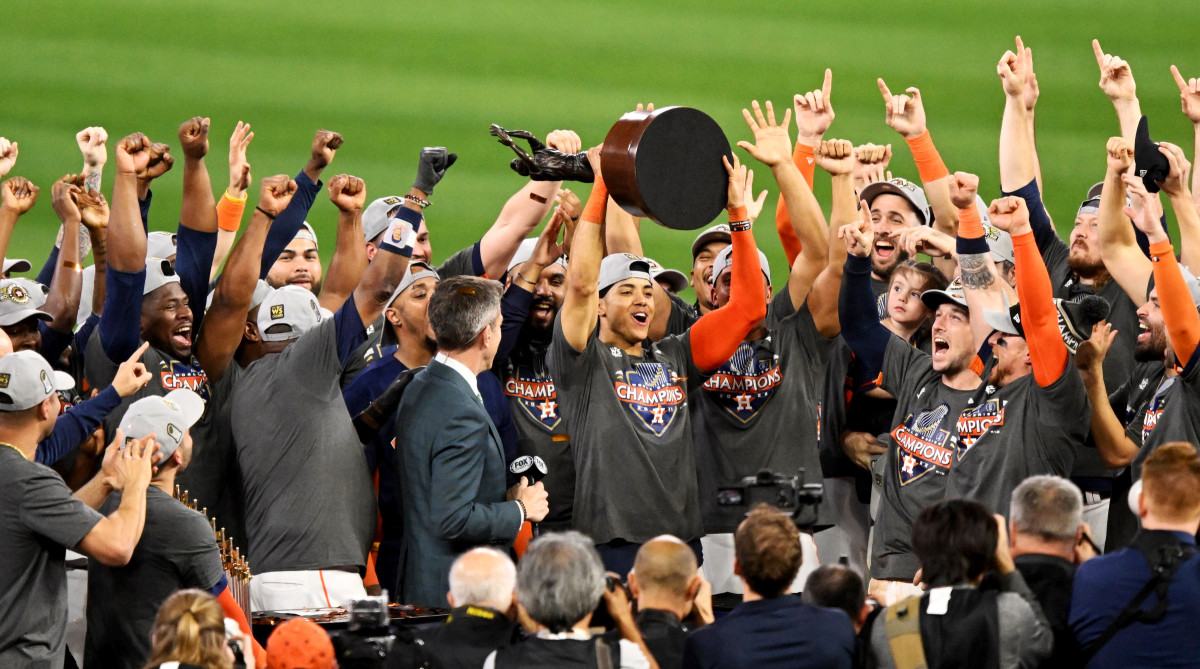 Astros shortstop Jeremy Peña holds up the World Series MVP trophy.